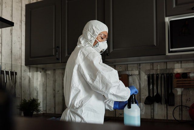 Person in White Closing Spray Bottle
